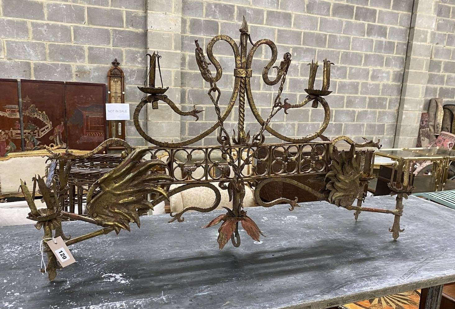 A medieval style gilt painted wrought iron hanging candle holder, width 106cm, height excluding chain 64cm